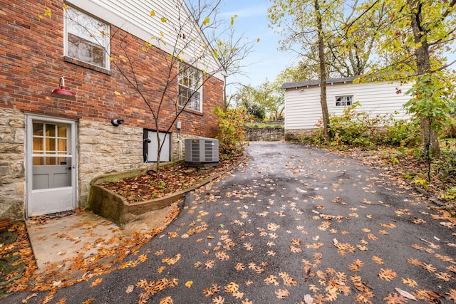 view of home's exterior featuring central AC unit and a patio