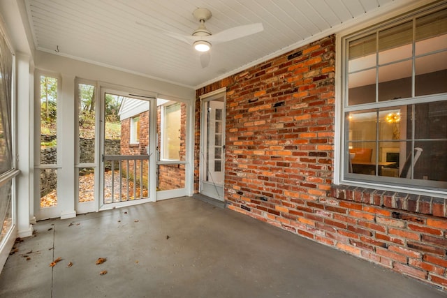 unfurnished sunroom with ceiling fan