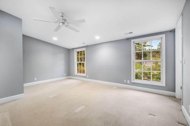 empty room featuring light carpet and ceiling fan