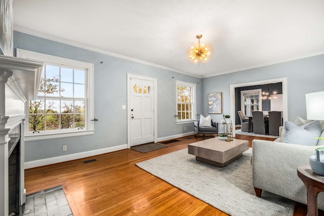 living room featuring crown molding, hardwood / wood-style floors, and a notable chandelier