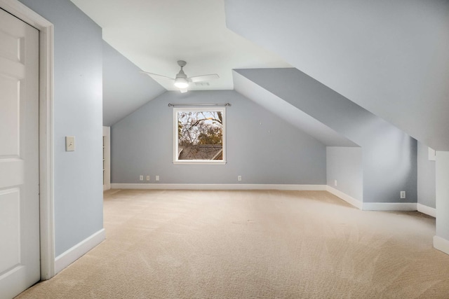 additional living space with ceiling fan, light colored carpet, and lofted ceiling