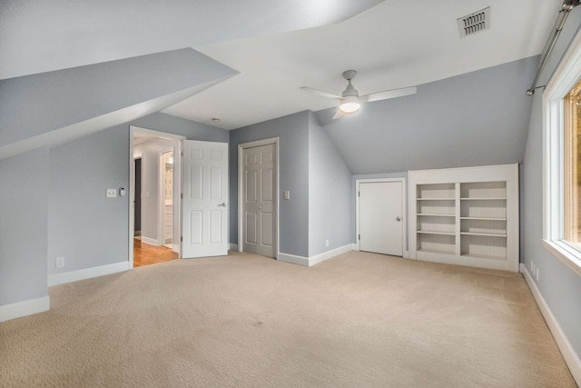 additional living space with ceiling fan, light carpet, and lofted ceiling