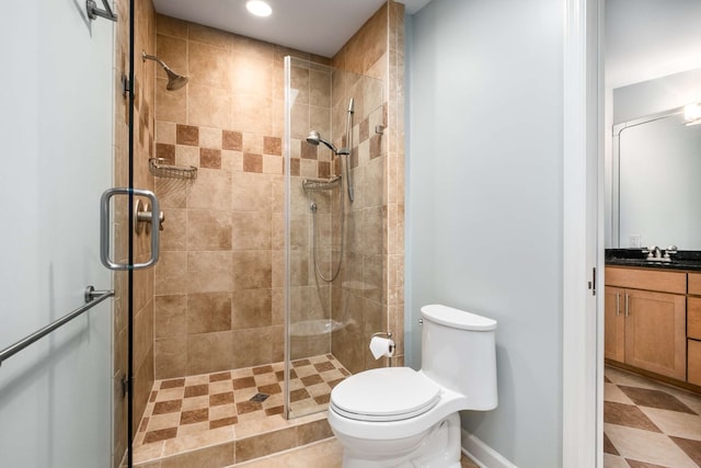 bathroom with vanity, toilet, and a shower with shower door