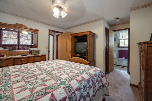 carpeted bedroom featuring ornamental molding, ceiling fan, and a textured ceiling