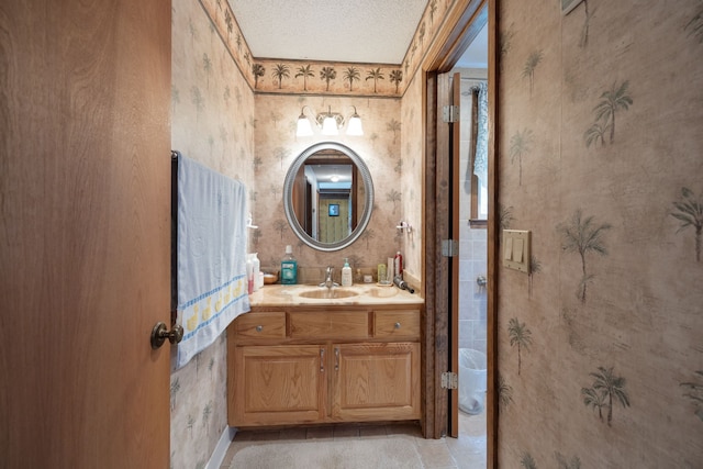 bathroom featuring a textured ceiling and vanity