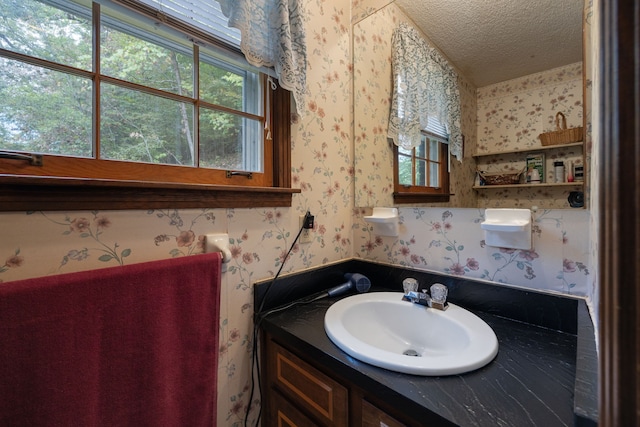 bathroom featuring a textured ceiling and vanity