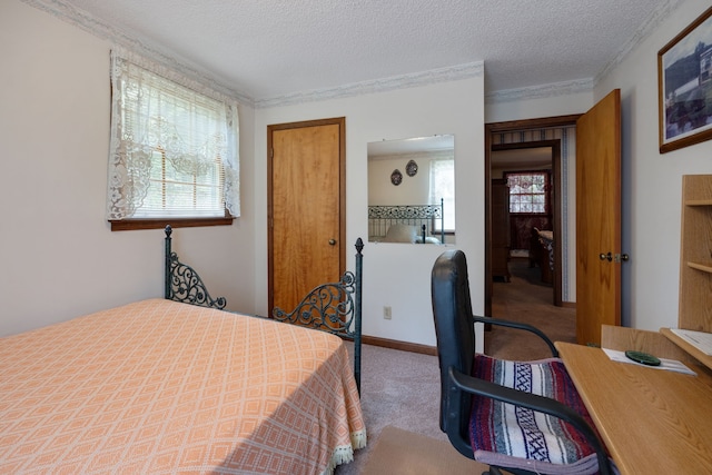 carpeted bedroom featuring a textured ceiling