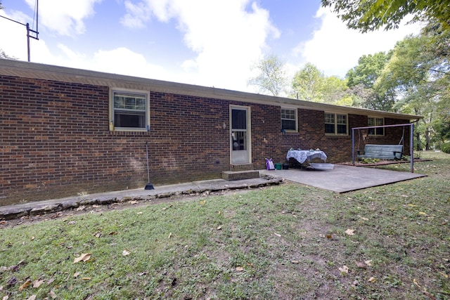 back of property featuring a patio and a yard