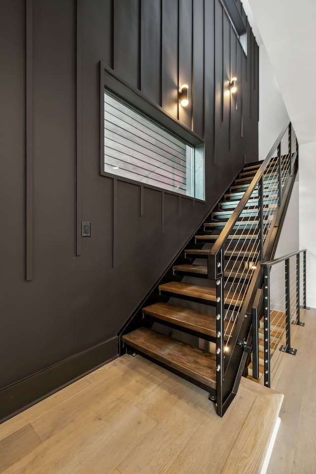 staircase with hardwood / wood-style flooring