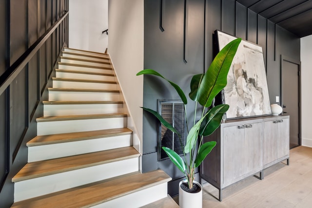 stairs featuring hardwood / wood-style flooring