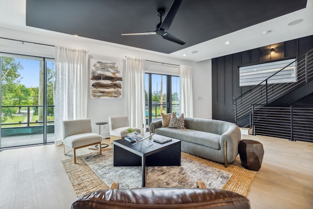 living area featuring recessed lighting, ceiling fan, stairway, and wood finished floors