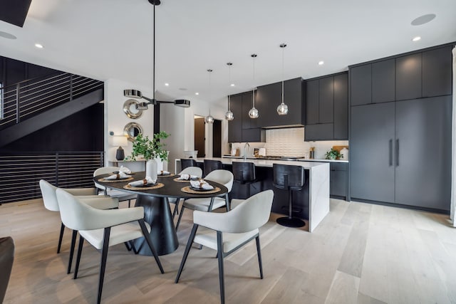 dining room featuring light wood-style flooring and recessed lighting