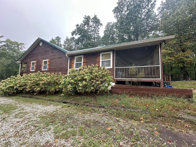 view of front of house with a sunroom