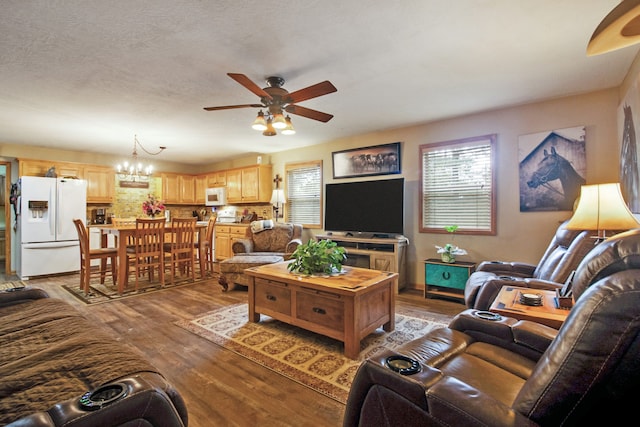 living room with a textured ceiling, ceiling fan with notable chandelier, and light hardwood / wood-style floors