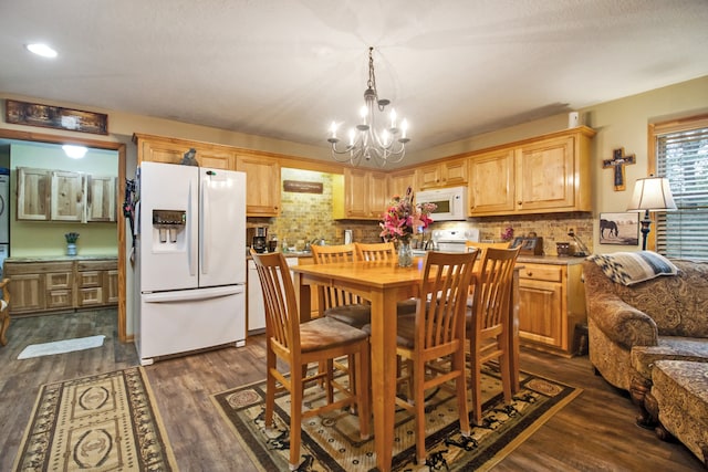 kitchen featuring tasteful backsplash, a notable chandelier, white appliances, dark hardwood / wood-style flooring, and light brown cabinetry