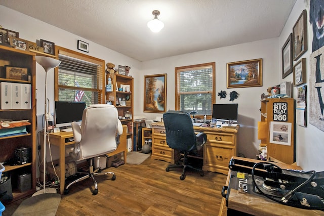 office with wood-type flooring and a textured ceiling