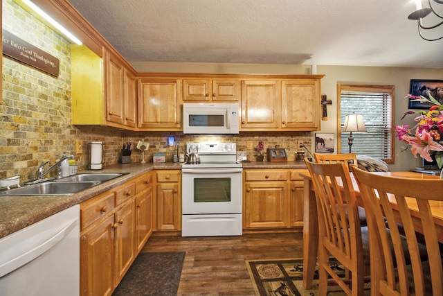 kitchen featuring decorative backsplash, white appliances, sink, and dark wood-type flooring