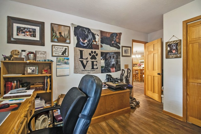 office with an inviting chandelier, a textured ceiling, and dark hardwood / wood-style flooring