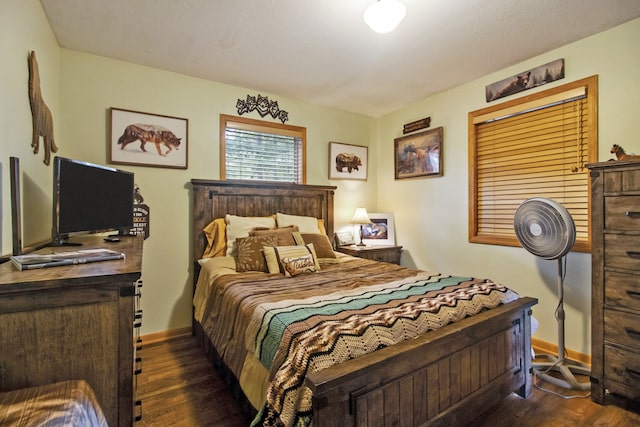 bedroom with dark hardwood / wood-style floors