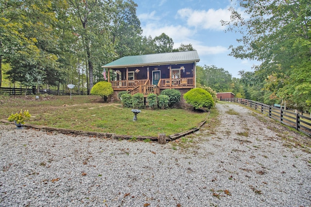 view of front of home featuring a rural view and a wooden deck