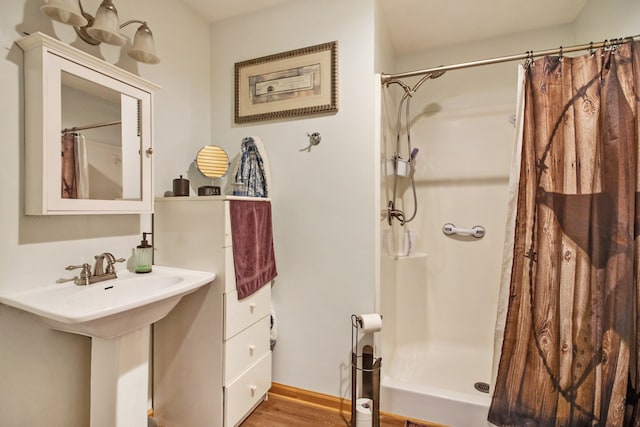 bathroom featuring a shower with curtain, hardwood / wood-style flooring, and sink