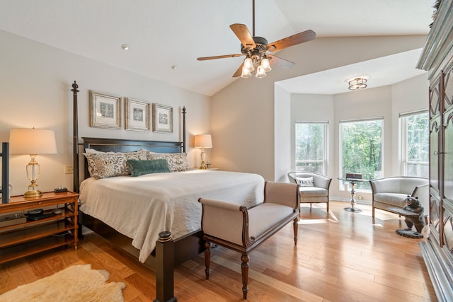 bedroom featuring light hardwood / wood-style floors, ceiling fan, and vaulted ceiling