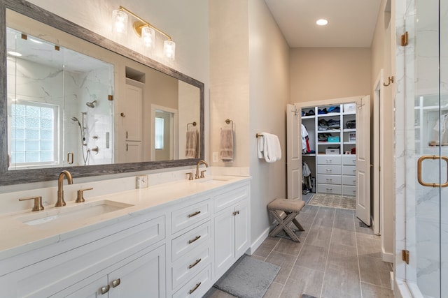 bathroom with vanity and a shower with shower door