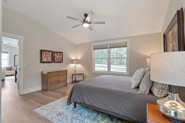 bedroom featuring ceiling fan, lofted ceiling, and light hardwood / wood-style floors