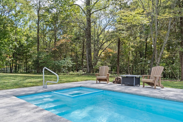 view of pool with a patio, a lawn, and an outdoor fire pit