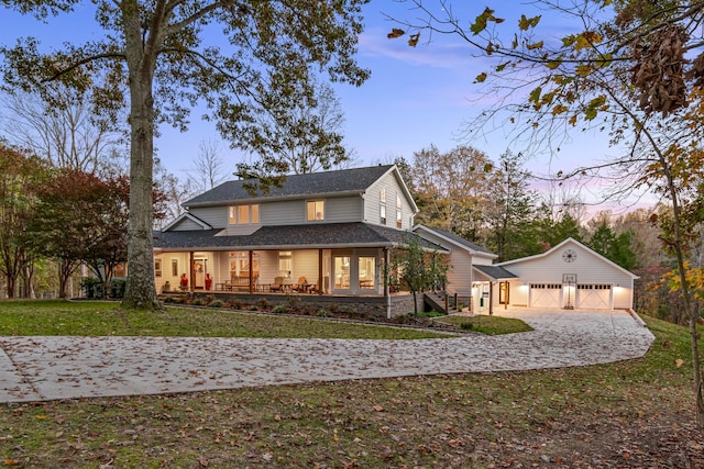 exterior space with an outdoor structure, a lawn, covered porch, and a garage