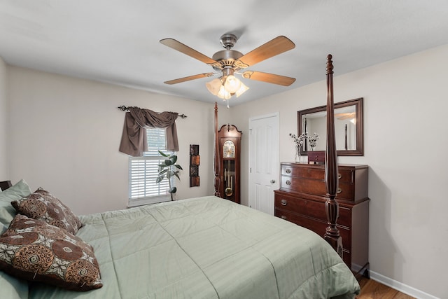 bedroom with ceiling fan and hardwood / wood-style flooring