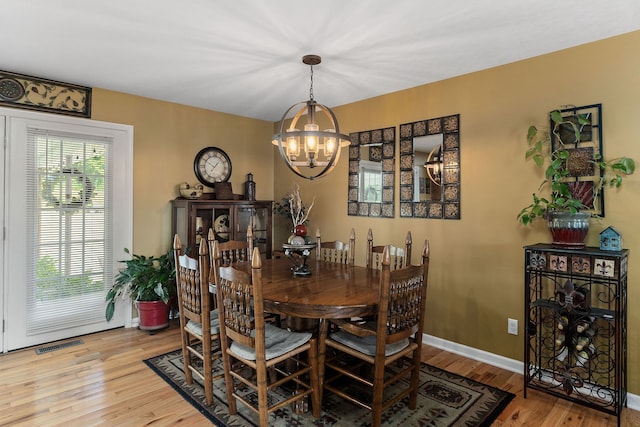 dining area featuring a chandelier and light hardwood / wood-style floors