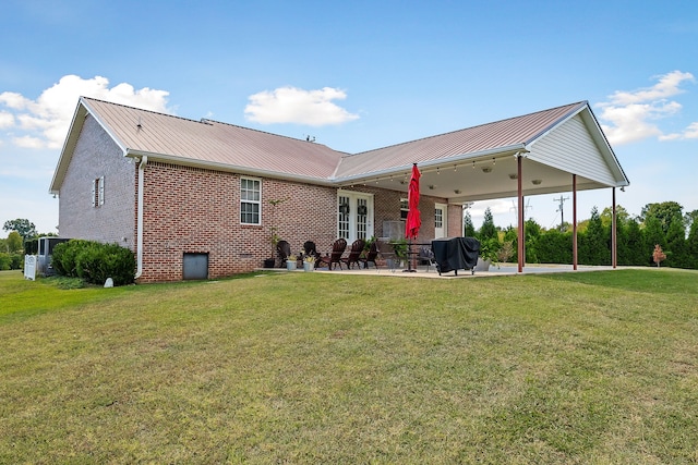 back of house featuring ceiling fan, a yard, and a patio area