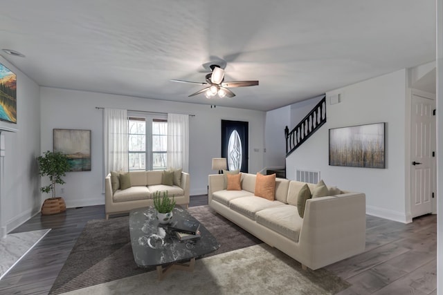 living room featuring ceiling fan and dark hardwood / wood-style floors