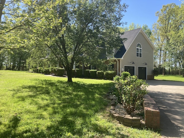 view of front of house featuring a garage and a front lawn