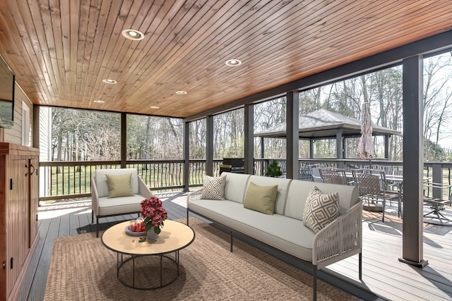 sunroom with wooden ceiling and plenty of natural light