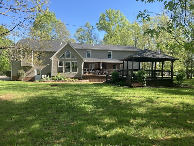 rear view of property with a lawn, a gazebo, and a wooden deck