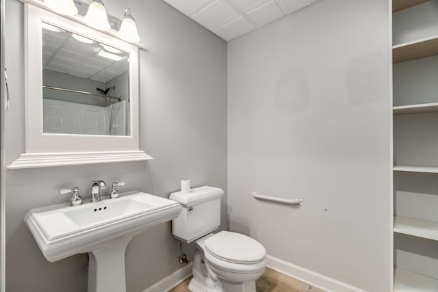 bathroom featuring a shower and toilet