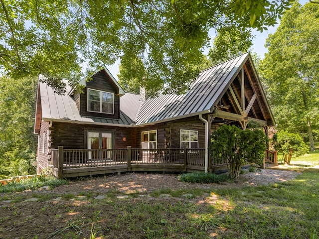 back of house with a wooden deck