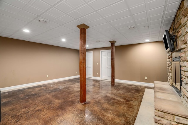 basement with a stone fireplace