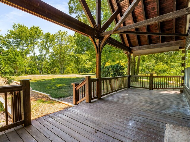 wooden terrace featuring a yard