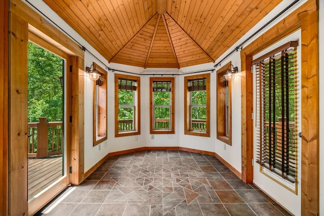 unfurnished sunroom featuring wood ceiling and lofted ceiling