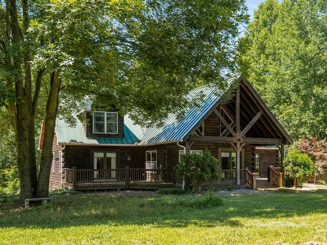 rear view of house with a yard and covered porch