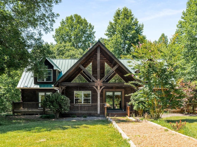 log-style house featuring a front lawn