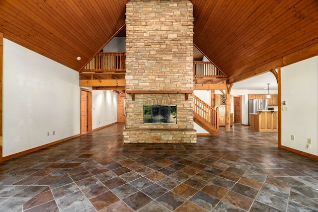 unfurnished living room with wooden ceiling, a fireplace, and high vaulted ceiling