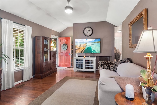 living room featuring lofted ceiling, ceiling fan, and dark hardwood / wood-style floors