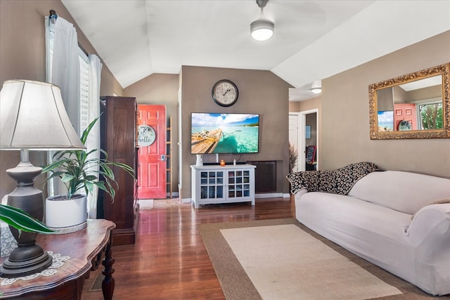 living room featuring vaulted ceiling, dark hardwood / wood-style flooring, and ceiling fan