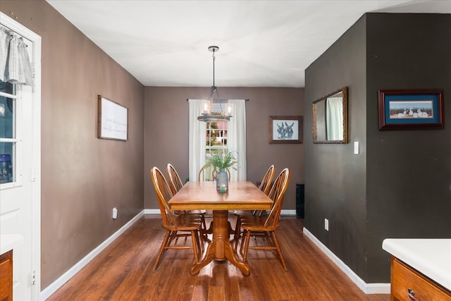 dining room with an inviting chandelier and dark hardwood / wood-style floors