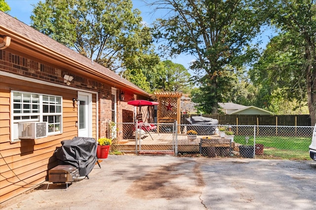 view of patio / terrace with a wooden deck, cooling unit, and a grill