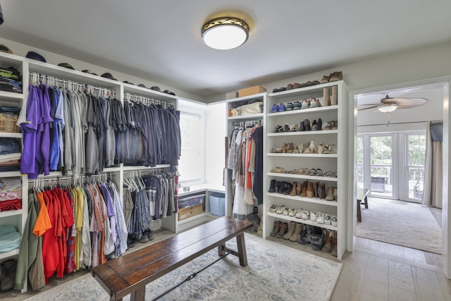 walk in closet with hardwood / wood-style flooring and ceiling fan